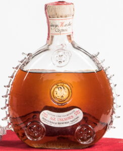 Age Unknown without 'very old'; 9 fins on both sides; 4/5 quart and 70 proof stated. Looks UK because of 70 proof, but has a US tax stamp and comes in a red velvet box! (1938-1940)