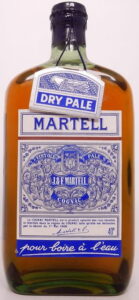 With a longer capsule over the spring cap; with a black label (1950s)