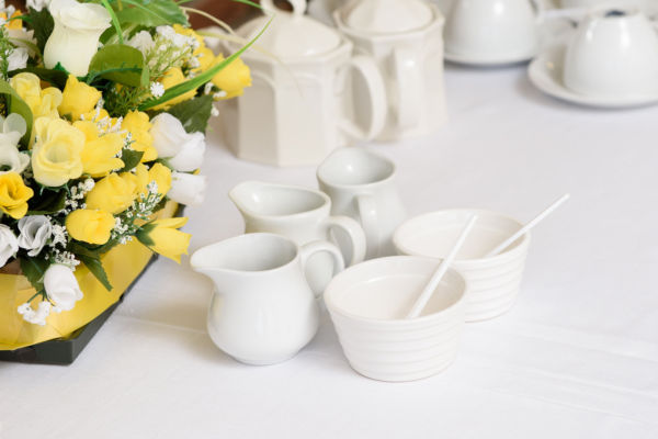 milk jugs and flowers on dining table