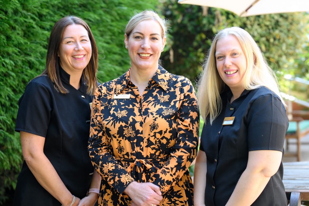 Home manager and team members smiling at the camera