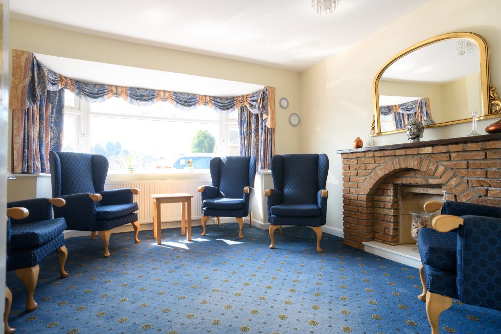 Common area with blue armchairs