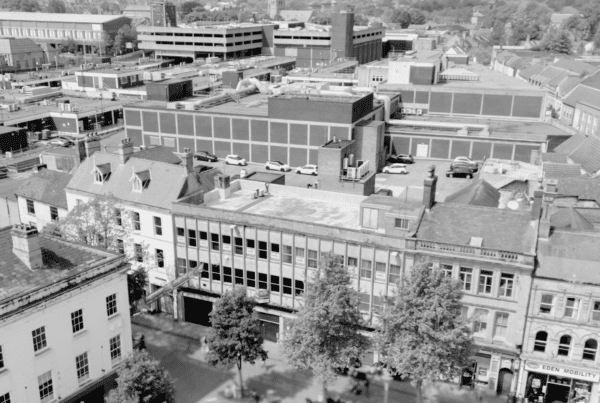 A black and white image of a highstreet with a focus on an individual bank building