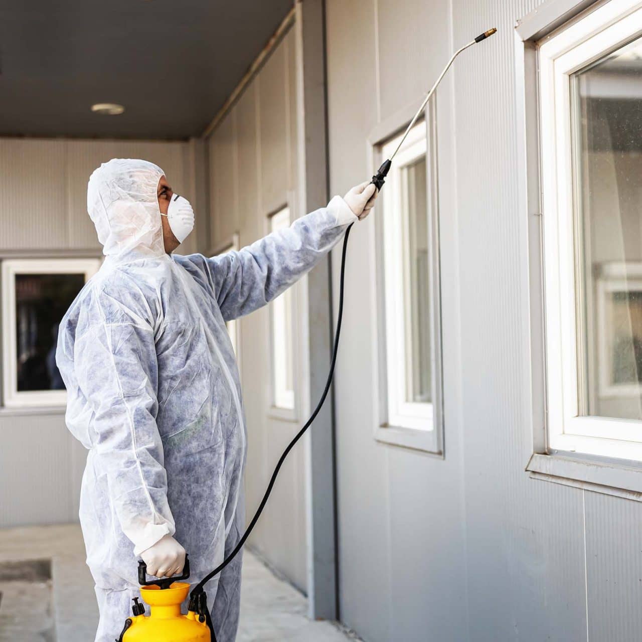 Specialist in hazmat suits cleaning and disinfecting coronavirus Specialist in hazmat suits cleaning and disinfecting coronavirus cells epidemic, world pandemic health risk.