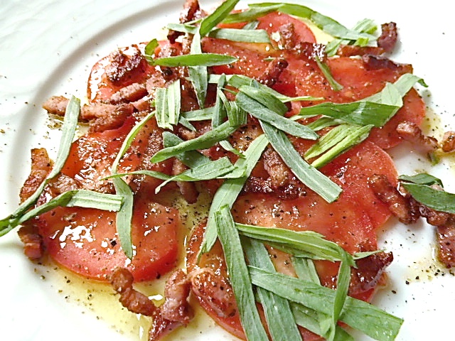 Tomatensalat mit gebratenen Speck, Olivenöl, Zitronensaft und frischen Estragon