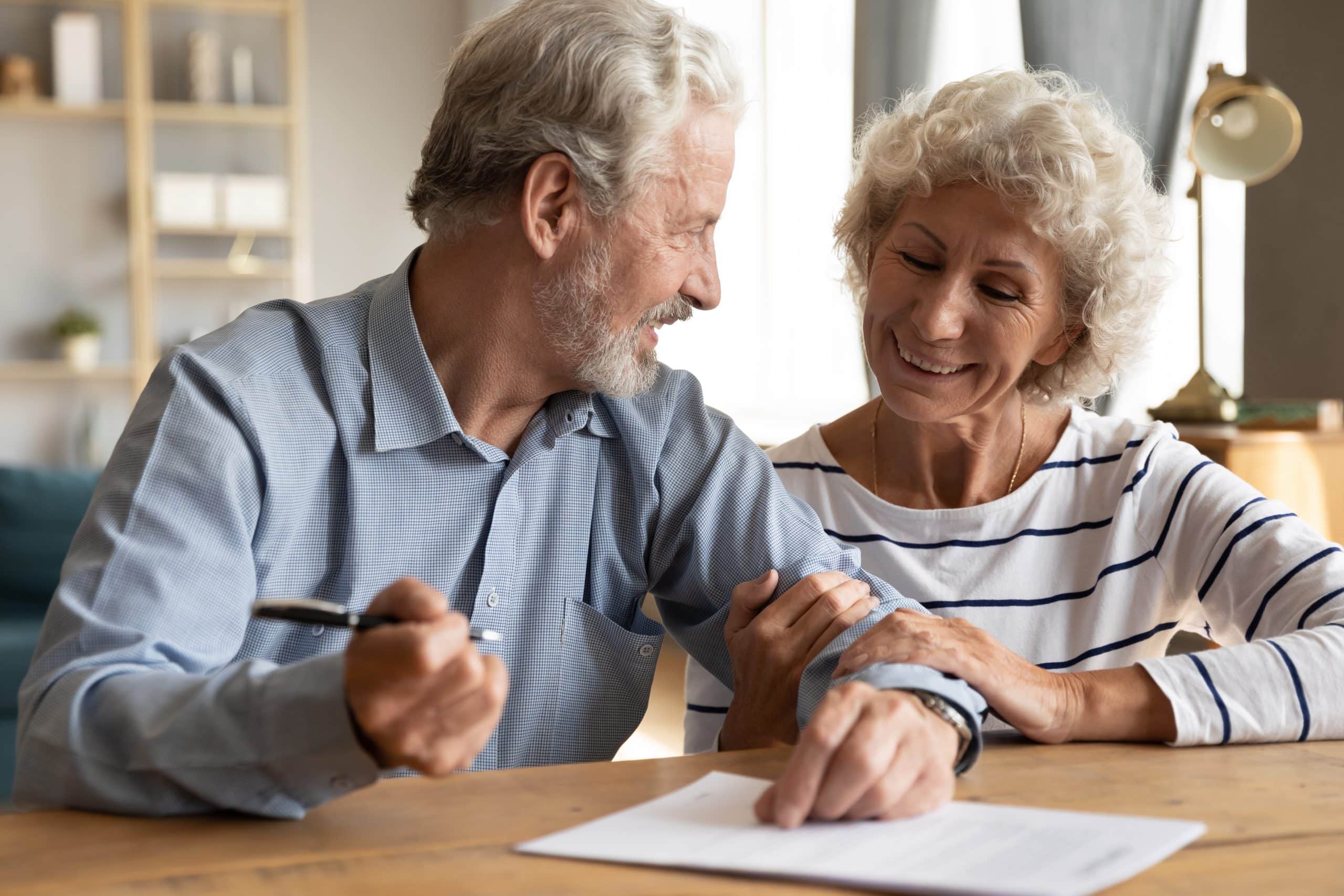 70s,Couple,Sit,At,Table,Indoor,Discuss,Agreement,Term,And