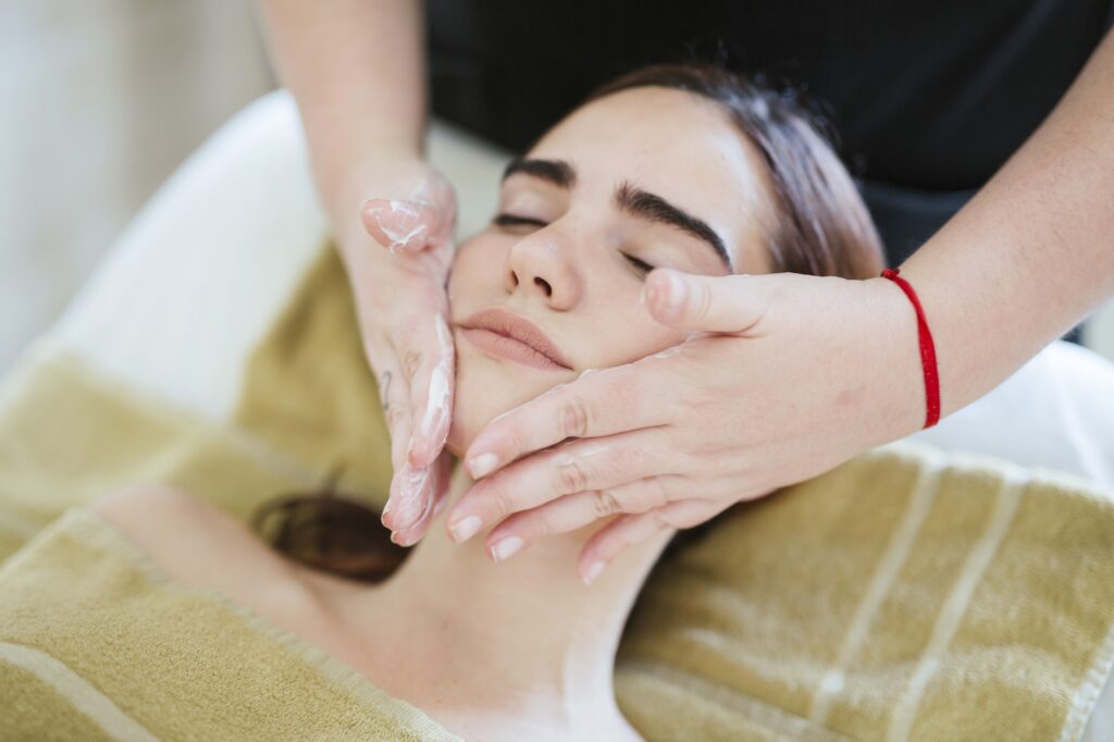 Young woman receiving facial beauty treatment in a spa