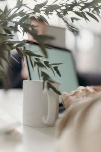 white ceramic mug on white table