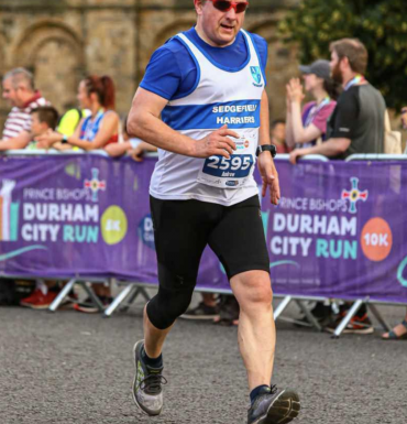 Full body picture of runner at Durham City Run 10k.