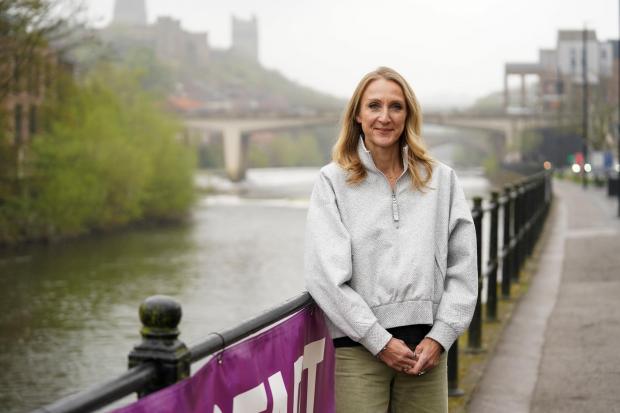 Woman standing next to a river.