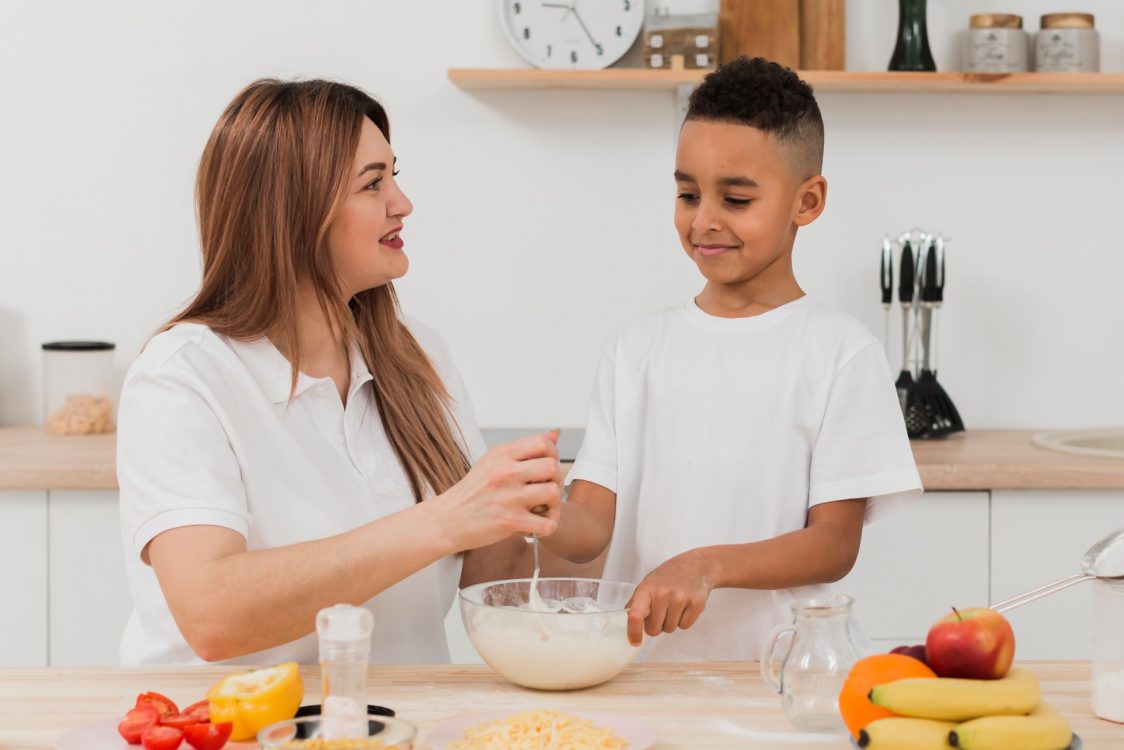 mother-teaching-son-prepare-food-kitchen