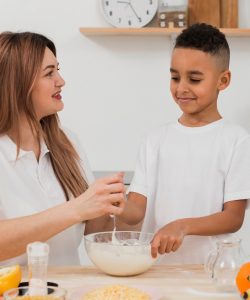 mother-teaching-son-prepare-food-kitchen mother-teaching-son-prepare-food-kitchen