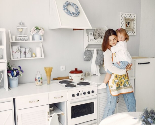 mother cooking with little daughter