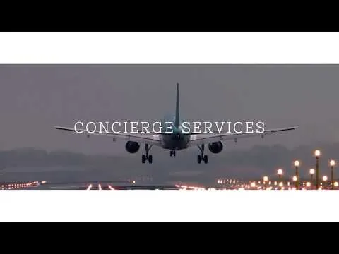 Commercial airplane taking off at dusk on runway with lights, text overlay "le Luxure Concierge Services"