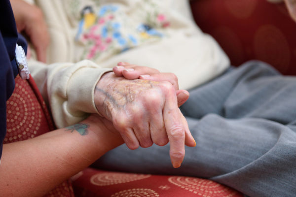 resident holding hands with team member