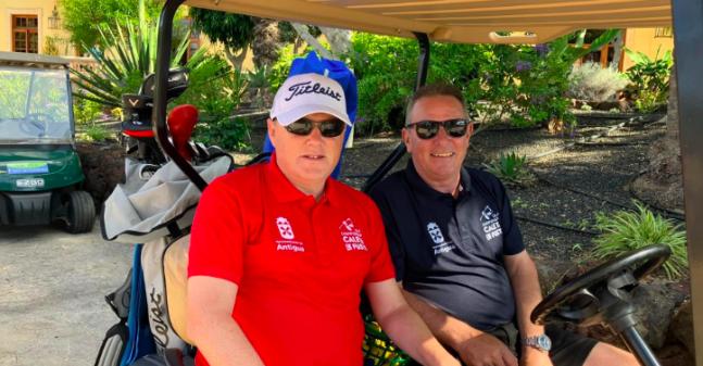 Billy and his Guide Tony on a Buggy at a golf course.