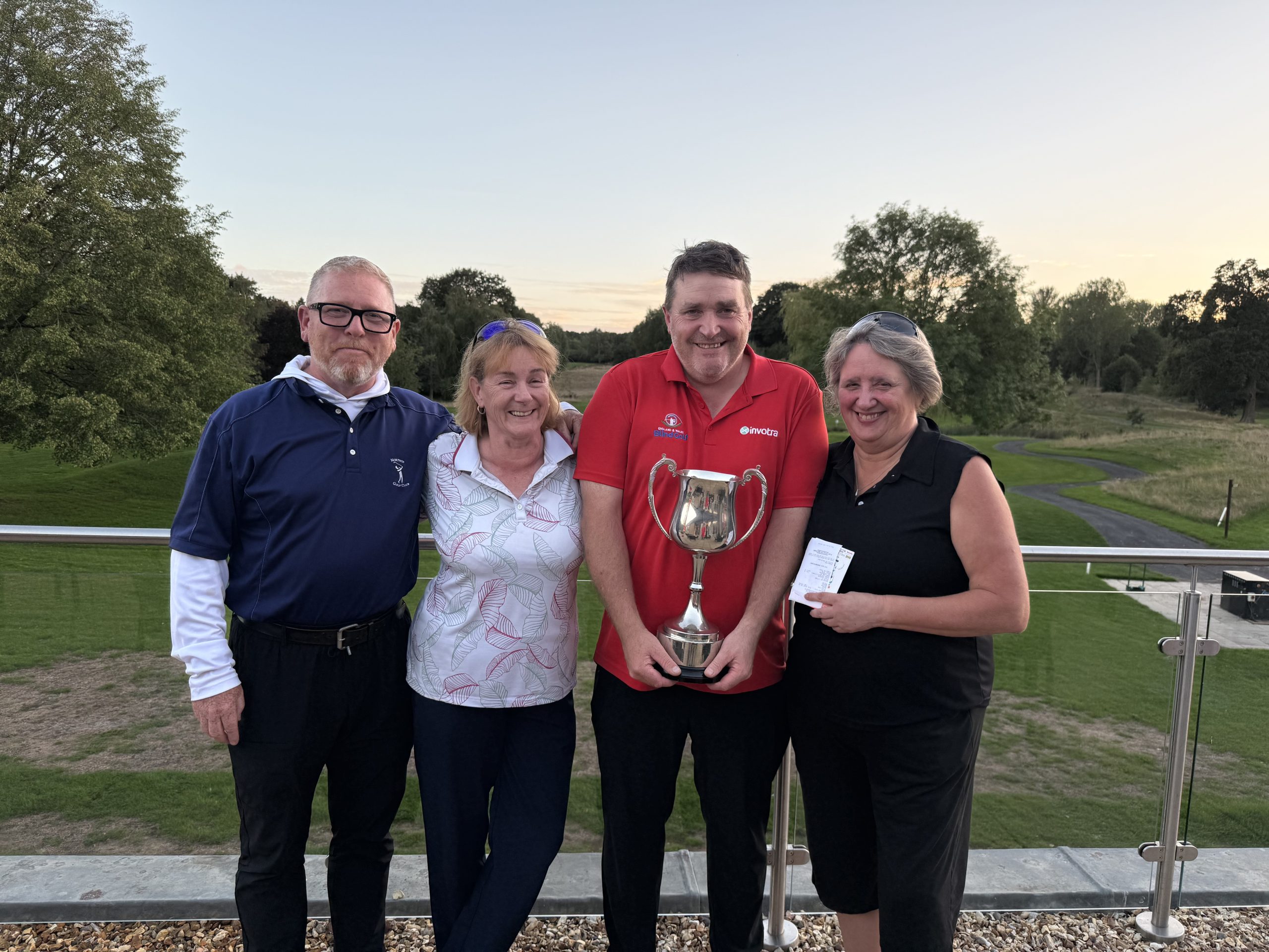 Photo shows Stuart and John and Debbie and Helen with their trophies.
