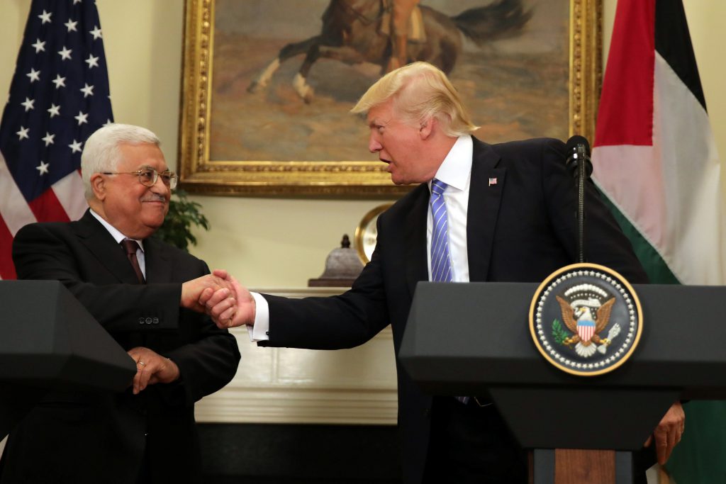 U.S. President Donald Trump shakes hands with Palestinian President Mahmoud Abbas as they deliver a statement at the White House in Washington D.C., U.S.