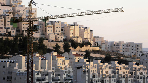 Fiie photo of crane next to homes in a Jewish settlement near Jerusalem