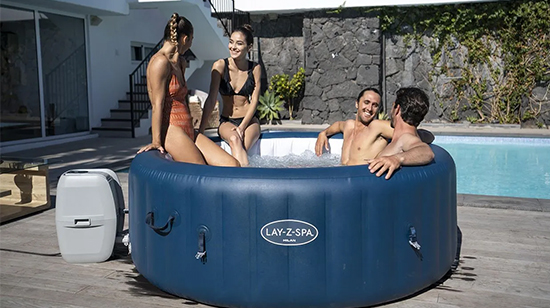 people enjoying using inflatable hot tub
