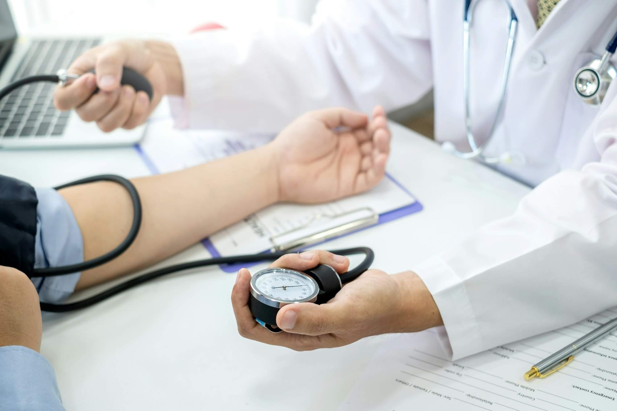 The doctor is checking the blood pressure of the patient.