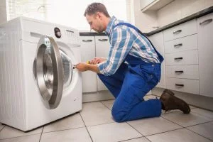 Home 50 depositphotos_60927609-stock-photo-handyman-fixing-a-washing-machine