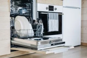 Home 69 Open Dishwasher with Clean Glasses and Dishes Close Up in Modern Kitchen