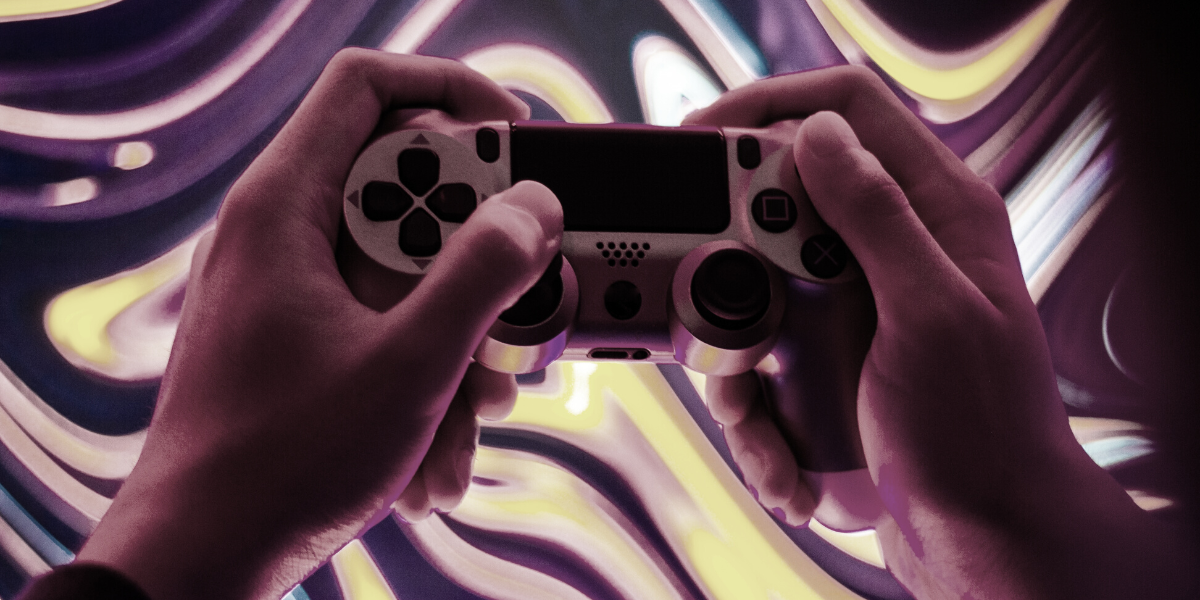 Picture shows a gaming controller being operated by two hands.