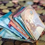 euro banknotes and coins on a table