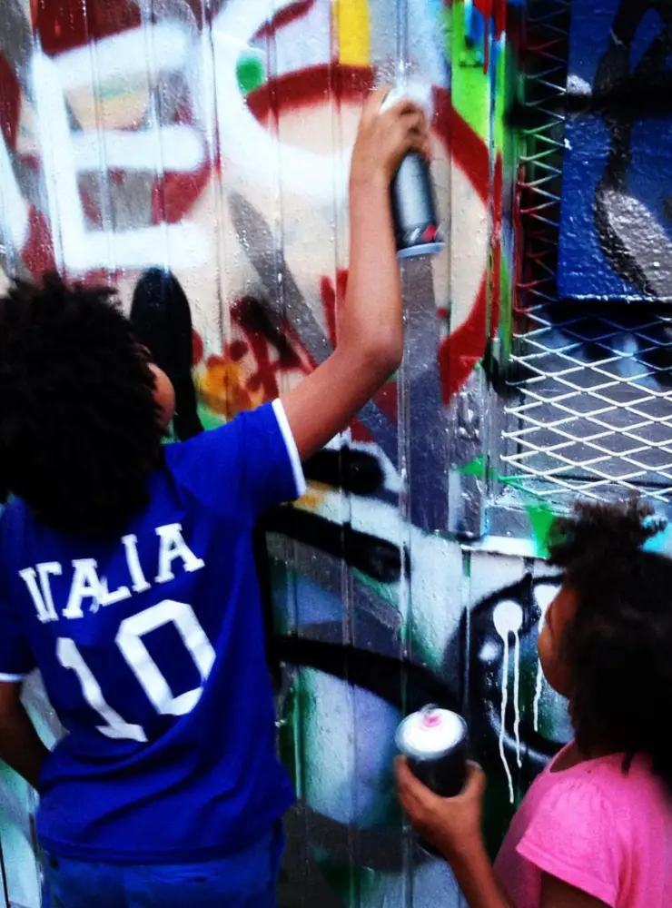 Kids painting graffiti and having fun.