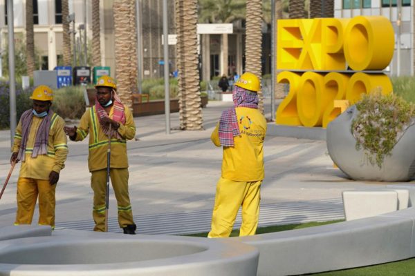 Workers clean an area at Expo 2020 in Dubai, United Arab Emirates, Oct. 3, 2021. The legions of workers who built Dubai's extravagant Expo 2020 site and keep it running face exploitation, grim conditions and a wide range of labor abuses, according to a new report by London-based rights consultancy Equidem released on Wednesday, Feb. 2, 2022