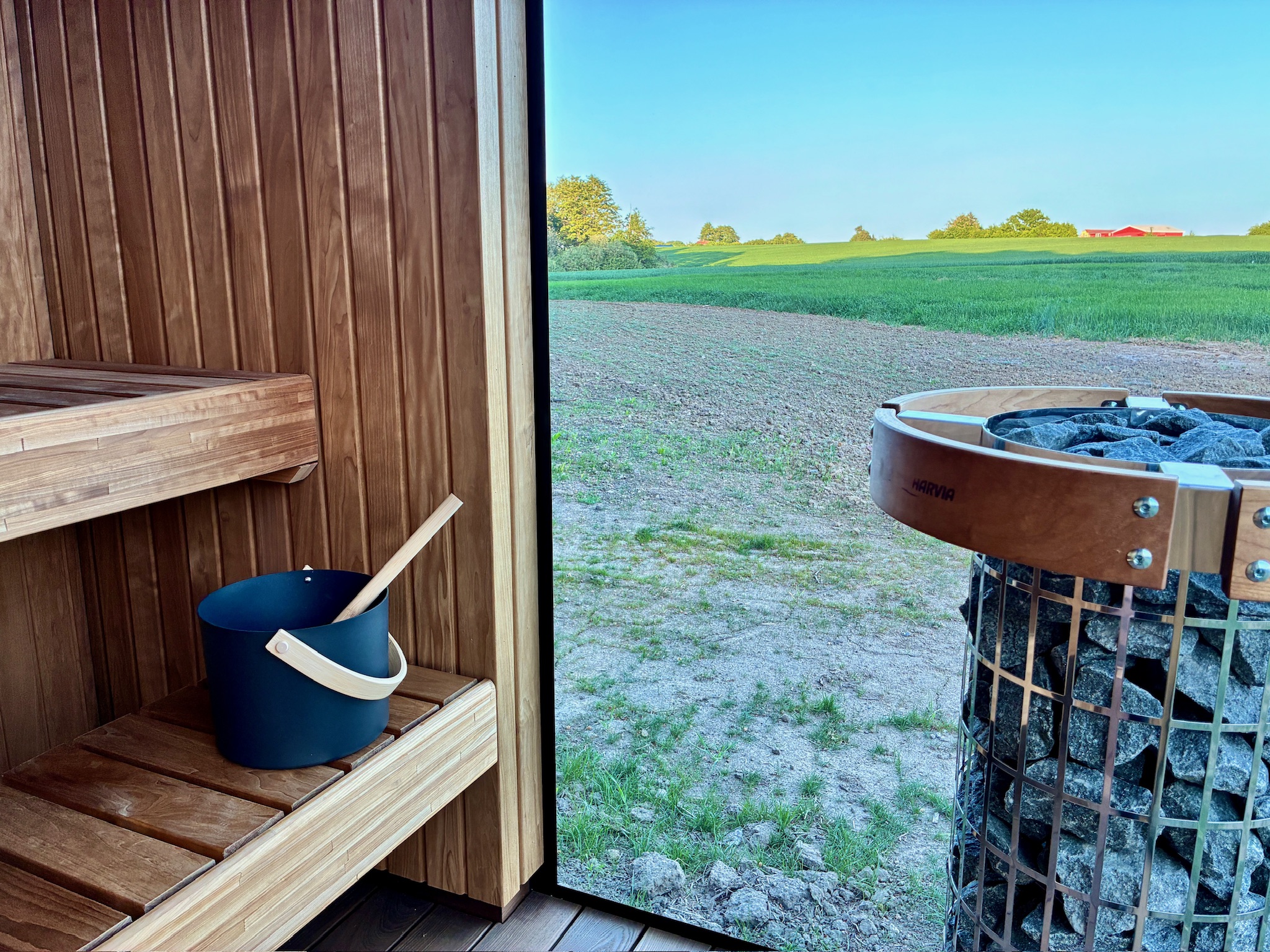 Inside the sauna at Glass Hut Mira, overlooking open fields