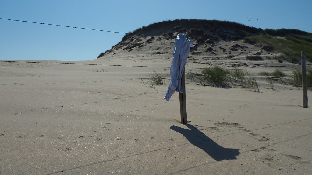 Wapperende blouse aan een paal op het strand