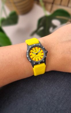 yellow childrens watch from gul watches on ladys arm
