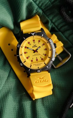waterproof yellow watch from gul watches on green shorts fabric