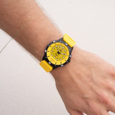 yellow Waterproof watch from gul watches on mans arm powered by sun light