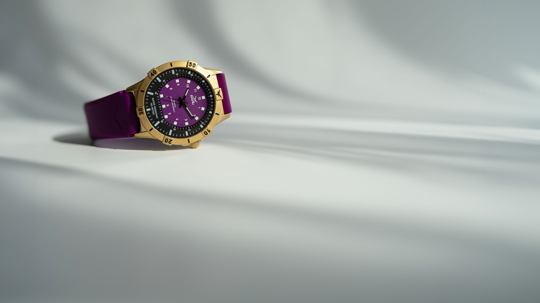 purple and gold watch from gul watches on white background