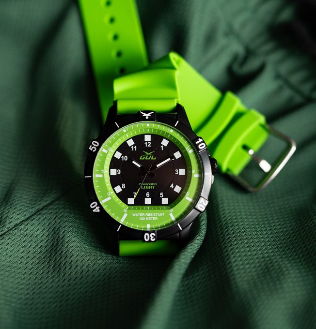 Green watch no.1 powered by light by Gul watches, on green fabric
