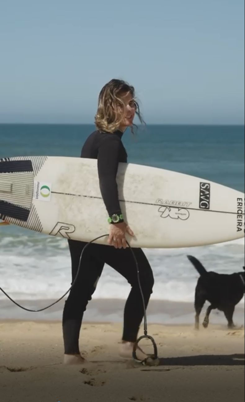 gul watches Progress surf school founder Joana walking with surfboard and watch