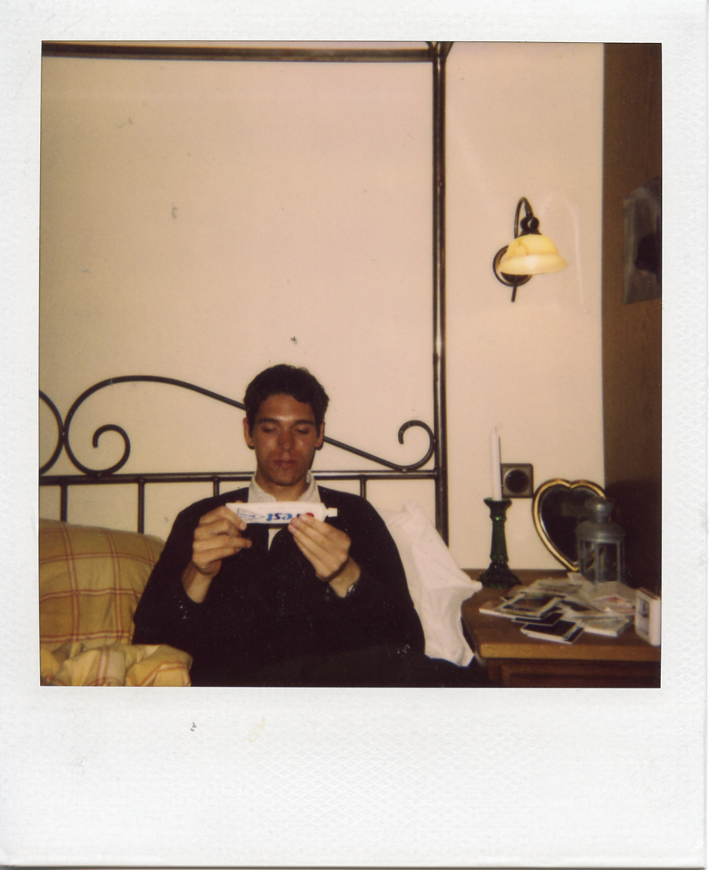 Dylan reading ingredients on some beauty product in my bed, Onsala.