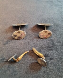 A pair of cufflinks and matching chest buttons