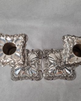 A pair of silver-plated metal candle holders (spot)