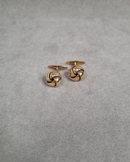 A pair of cufflinks in the form of knots