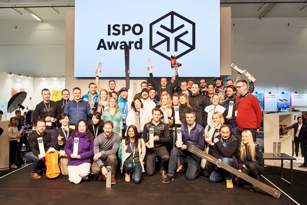 Group of people cheering on a stage in a venue