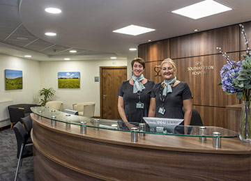 Our friendly team is there to support you through your recovery. This image shows two Hernia Clinic Hampshire team at the reception desk.