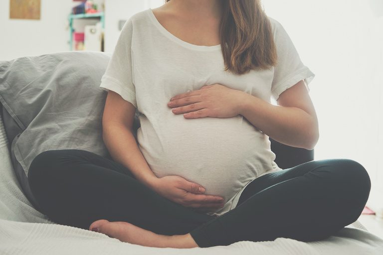 Pregnant woman touching her belly