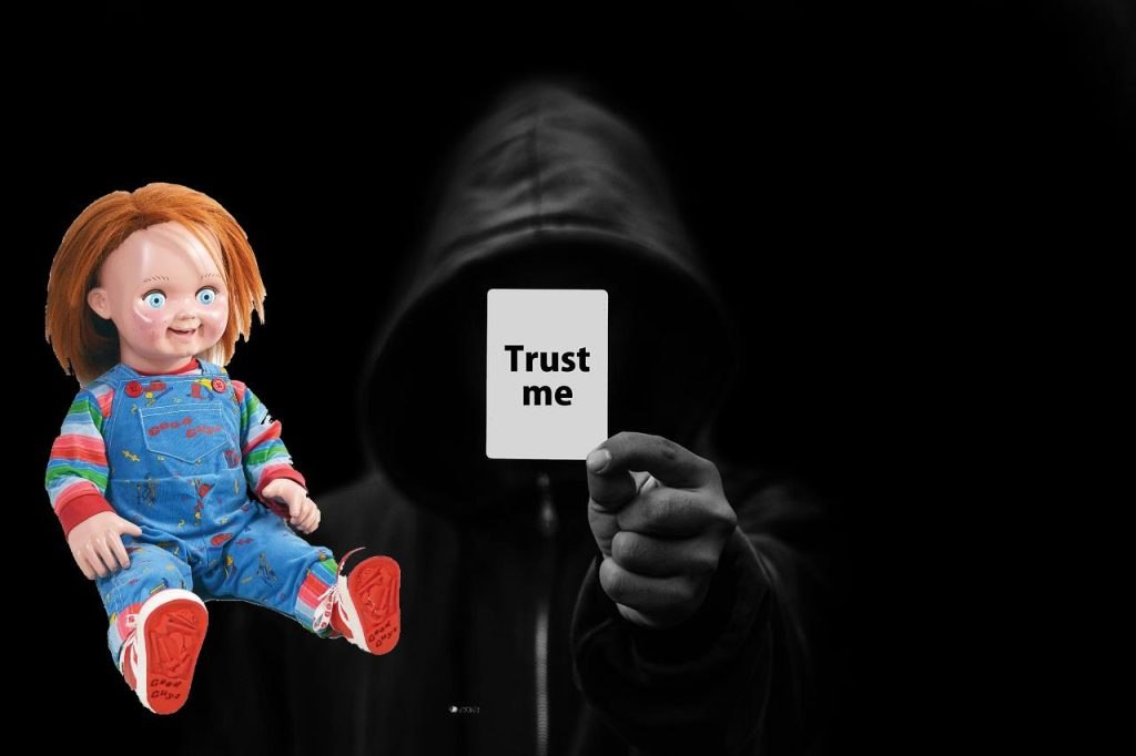 Illustrasjon som viser en dukke fra skrekkfilm til venstre og en anonym person i hette som holder et kort med teksten «Trust me» mot kamera, brukt som metafor for blind tillit og behovet for kildekritikk.