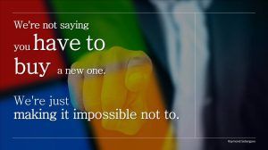 A digitally created image of a person in a suit pointing directly at the viewer, overlaid with the Microsoft logo colors. The text reads: "We're not saying you have to buy a new one. We're just making it impossible not to."