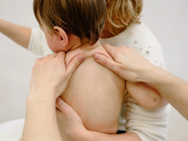 baby having a shoulder massage