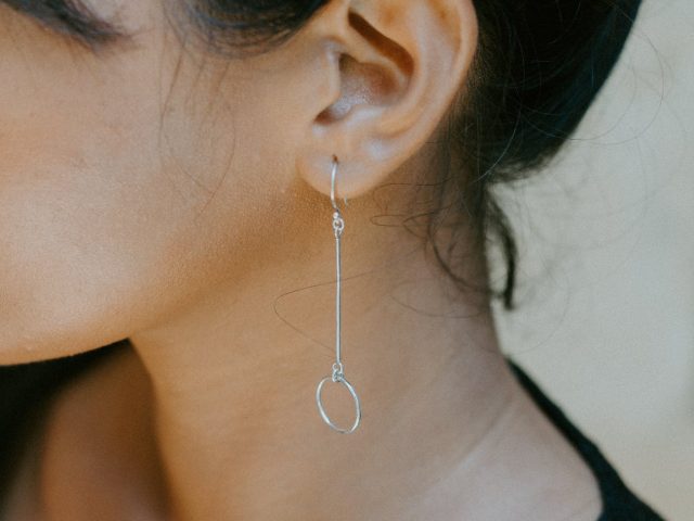 woman wearing silver colored earring