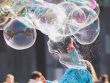 girl playing with bubbles